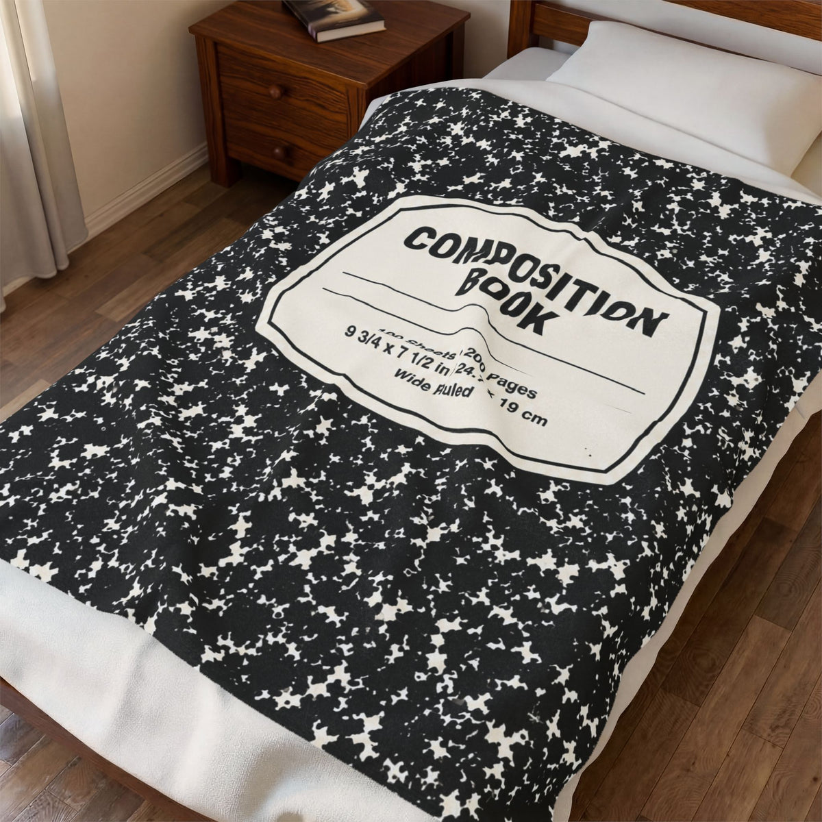 Composition Book Cover plush throw blanket with black marble notebook pattern and white label, spread across a bed