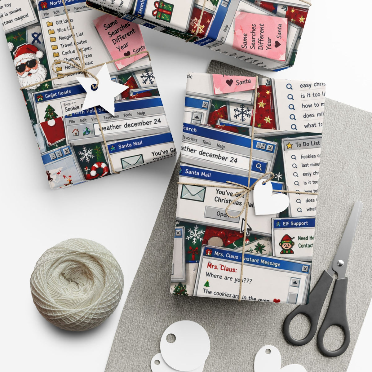 Two gifts wrapped in Santa’s Search History Christmas paper, with retro computer windows, twine and gift tags