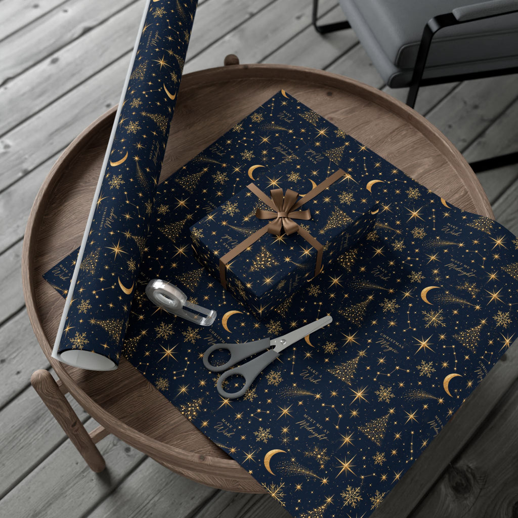 Midnight Stars Christmas wrapping paper in navy blue and gold, with crescent moons, shooting stars and celestial motifs on wrapped gifts