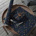 Midnight Stars Christmas wrapping paper in navy blue and gold, with crescent moons, shooting stars and celestial motifs on wrapped gifts